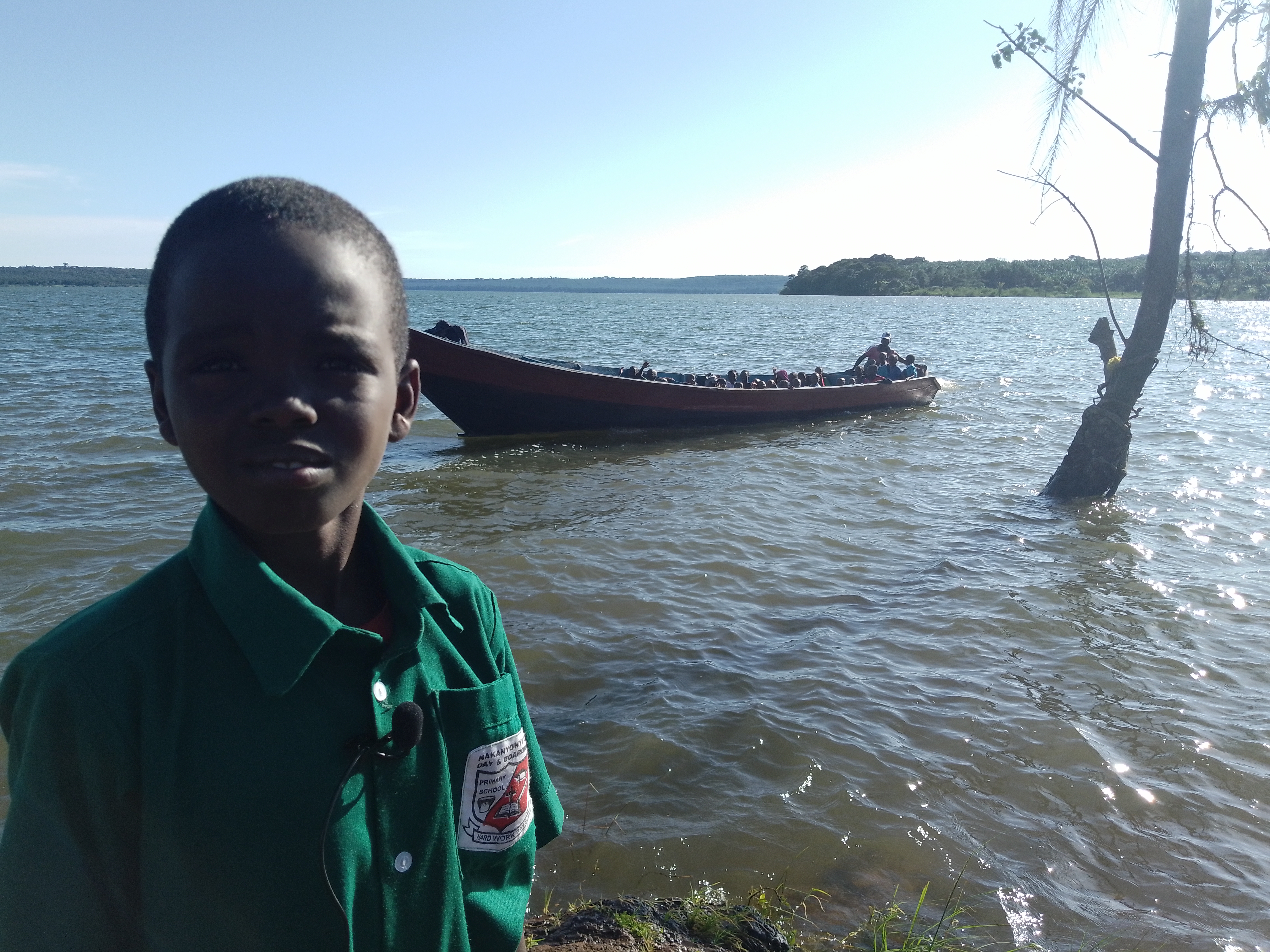 Behind Young Malikiswua Fludusi is a boat carrying fellow pupils back to Kagoonya Island